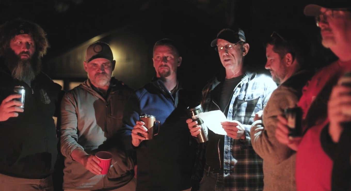 Veterans around the firepit at night.