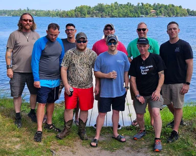 Brothers lined up along the lakeshore.
