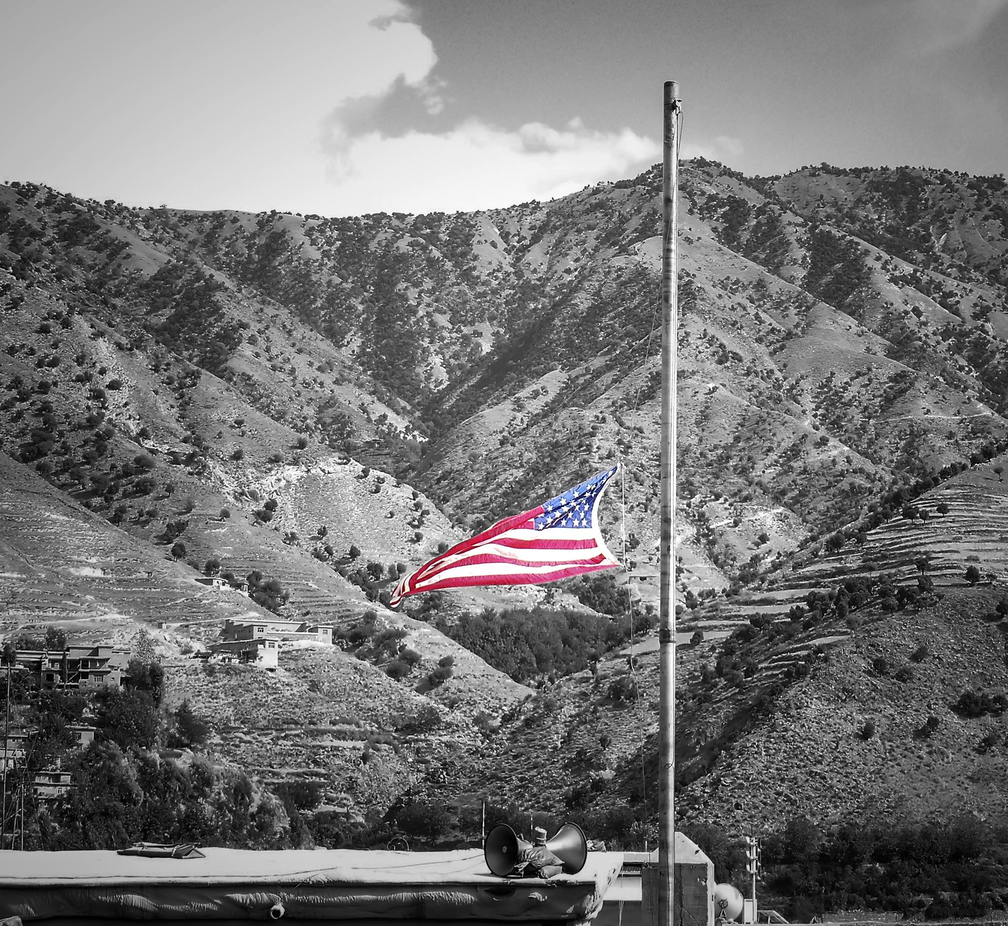 An American flag flies at half-staff over the mountains of eastern Afghanistan.